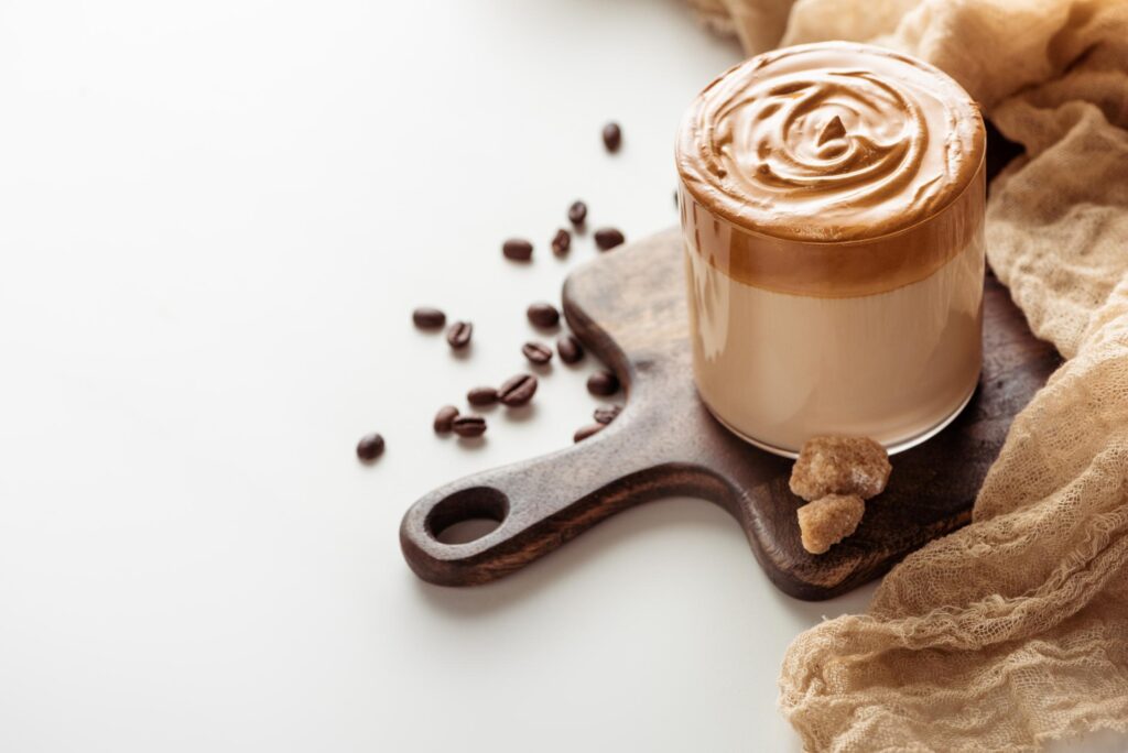 delicious dalgona coffee in glass on wooden cuttin 2022 12 16 18 38 09 utc